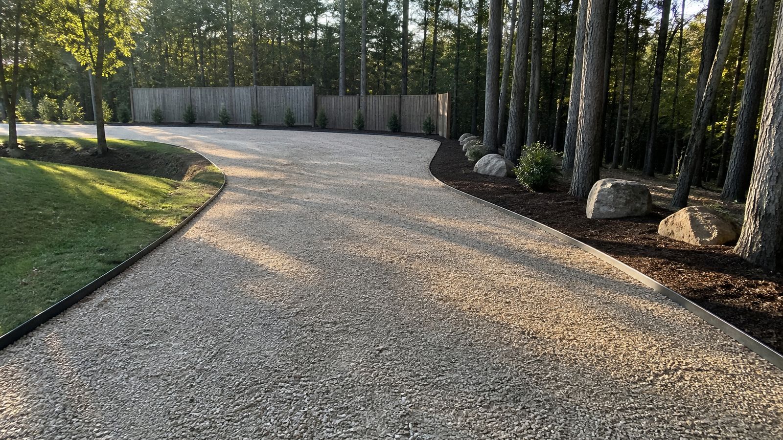 Freshly graded and compacted gravel driveway with crisp edging